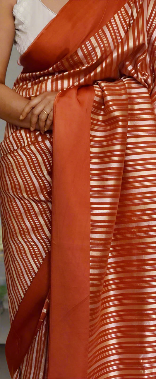 Party collections- Orange color saree with gold and silver stripes